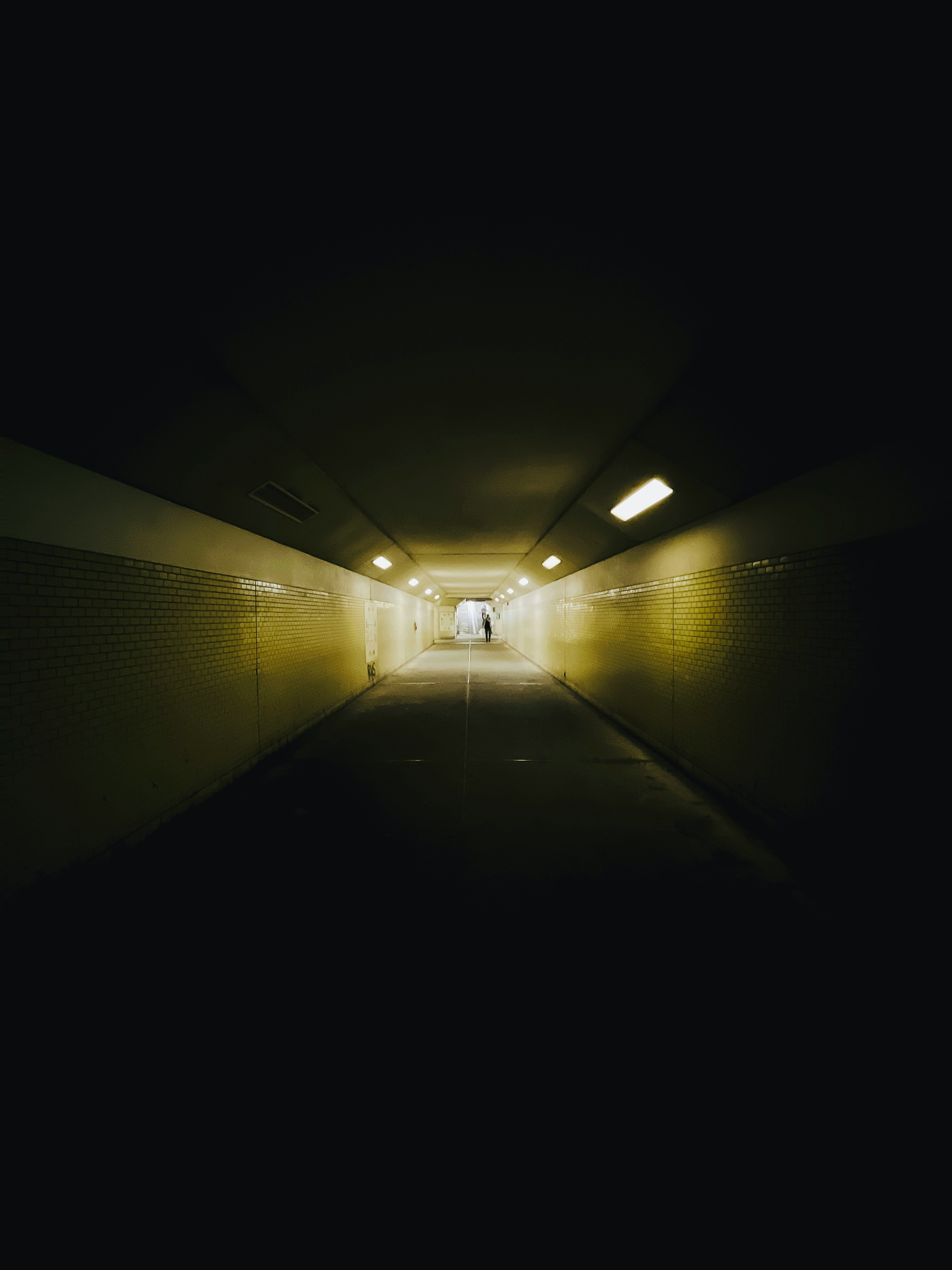 white light bulb turned on in tunnel